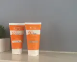 Deux tubes de spray solaire invisible SPF 50 Avène, l'un teinté, l'autre non, pour une protection optimale.